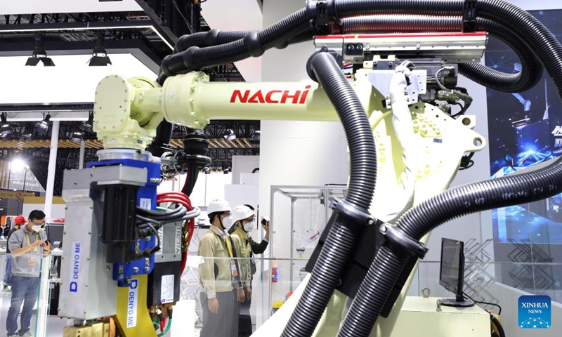 Technicians of Japanese company Nachi-Fujikoshi Corp. debug their equipment to be displayed in the upcoming fifth China International Import Expo (CIIE) in east China's Shanghai, Nov. 2, 2022. The fifth CIIE will be held in Shanghai from Nov. 5 to 10. Representatives from a total of 145 countries, regions and international organizations will participate in the upcoming fifth China International Import Expo (CIIE) in Shanghai, the organizer said on Tuesday.(Photo: Xinhua)