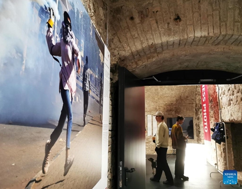 Visitors are seen at the World Press Photo Exhibition 2022 in Vilnius, Lithuania on Nov. 2, 2022. The exhibition, which opened on Oct. 29, showcases the winning photographs from the 65th annual World Press Photo Contest.(Photo: Xinhua)