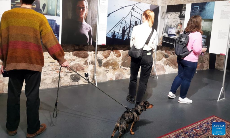 Visitors view photographs exhibited at the World Press Photo Exhibition 2022 in Vilnius, Lithuania on Nov. 2, 2022. The exhibition, which opened on Oct. 29, showcases the winning photographs from the 65th annual World Press Photo Contest.(Photo: Xinhua)