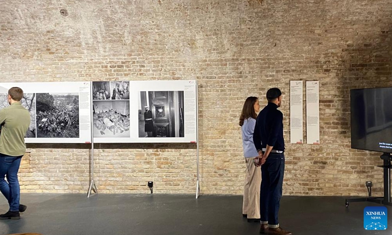 Visitors are seen at the World Press Photo Exhibition 2022 in Vilnius, Lithuania on Nov. 2, 2022. The exhibition, which opened on Oct. 29, showcases the winning photographs from the 65th annual World Press Photo Contest.(Photo: Xinhua)