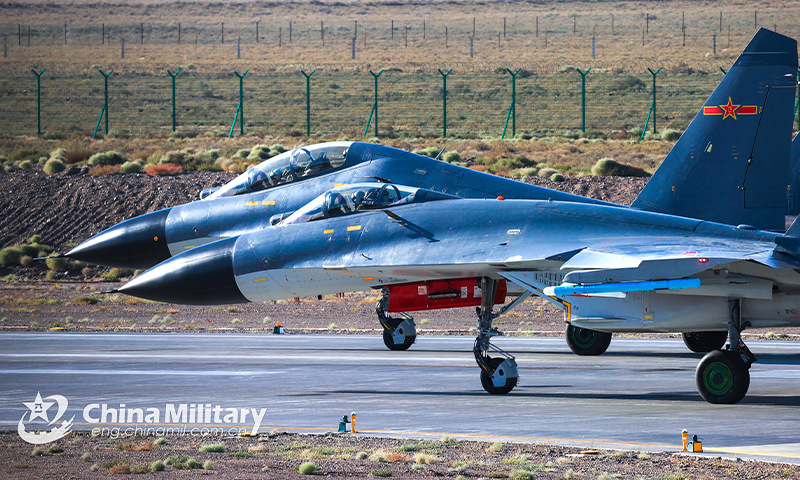 Fighter jets attached to an aviation brigade of the PLA Air Force taxi in formation on the runway before takeoff for a flight training exercise on September 29, 2022. (eng.chinamil.com.cn/Photo by Cui Baoliang)