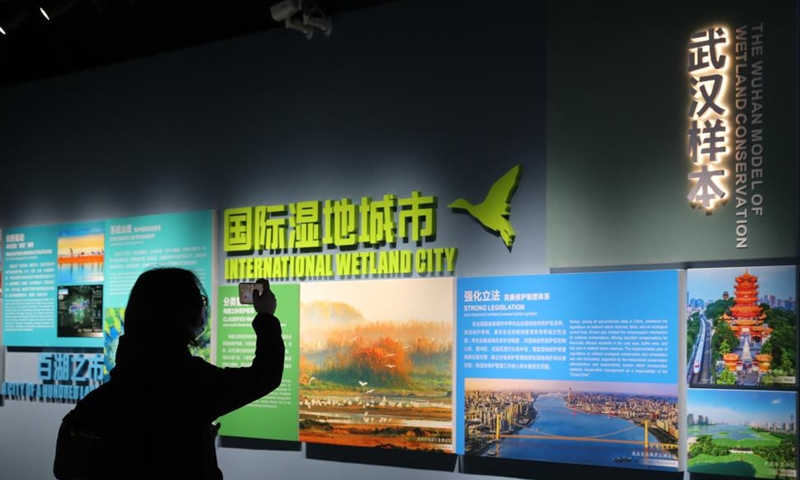 A visitor takes photos at China's Achievement Exhibition for the 30th Anniversary of Accession to the Ramsar Convention on Wetlands, in Wuhan, central China's Hubei Province, Nov. 6, 2022. The achievement exhibition kicked off here on Sunday. (Xinhua/Yao Qilin)