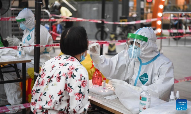 A medical worker takes a swab sample from a resident for nucleic acid test at a community in Liwan district of Guangzhou, South China's Guangdong province. Photo: Xinhua