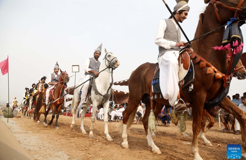 Horse riders prepare to compete during a tent pegging competition in Rawalpindi, Pakistan, Nov. 5, 2022. In tent pegging competition, a horseman gallops and uses a sword or a lance to pierce, pick up and carry away a wooden peg. (Xinhua/Ahmad Kamal)