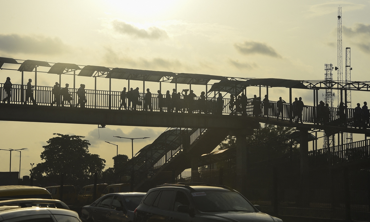 People walk on a pedestrian bridge in Lagos, Nigeria's commercial capital, in late October. Photo: AFP