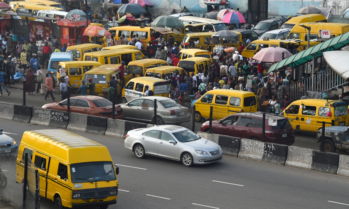 Commuters board yellow painted minibuses in Lagos, Nigeria's commercial capital, in late October. Photo: AFP