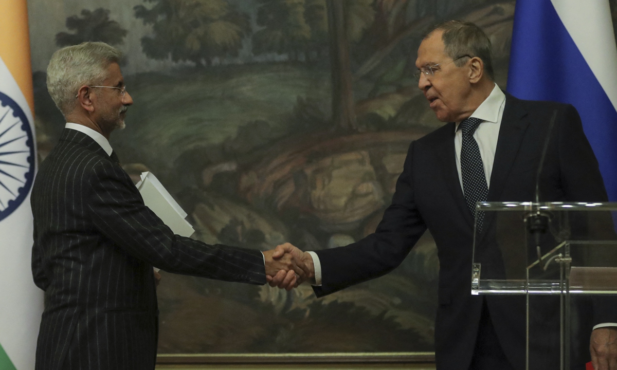 Russian Foreign Minister Sergei Lavrov (right) and his Indian counterpart Subrahmanyam Jaishankar shake hands during a joint press conference following their talks in Moscow on November 8, 2022. Jaishankar stated at the press conference that buying oil from Russia works to India's advantage and asserted that he would like to keep that going.