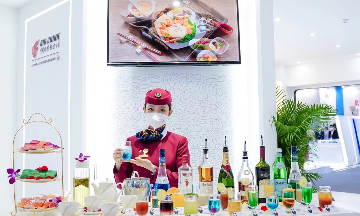 A stewardess shows the cabin drinks at the Zhuhai Airshow on December 8, 2022. Photo: Courtesy of Air China