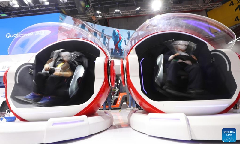 Visitors experience VR gaming capsules at the Intelligent Industry & Information Technology exhibition area of the fifth China International Import Expo (CIIE) in east China's Shanghai, Nov. 5, 2022. High-tech products and technologies focusing on improving visual perception in the fields of work, travel and entertainment, such as intelligent cockpit and microscopic imaging device, provide vivid and richer visual experience for visitors during the fifth CIIE in Shanghai.(Photo: Xinhua)