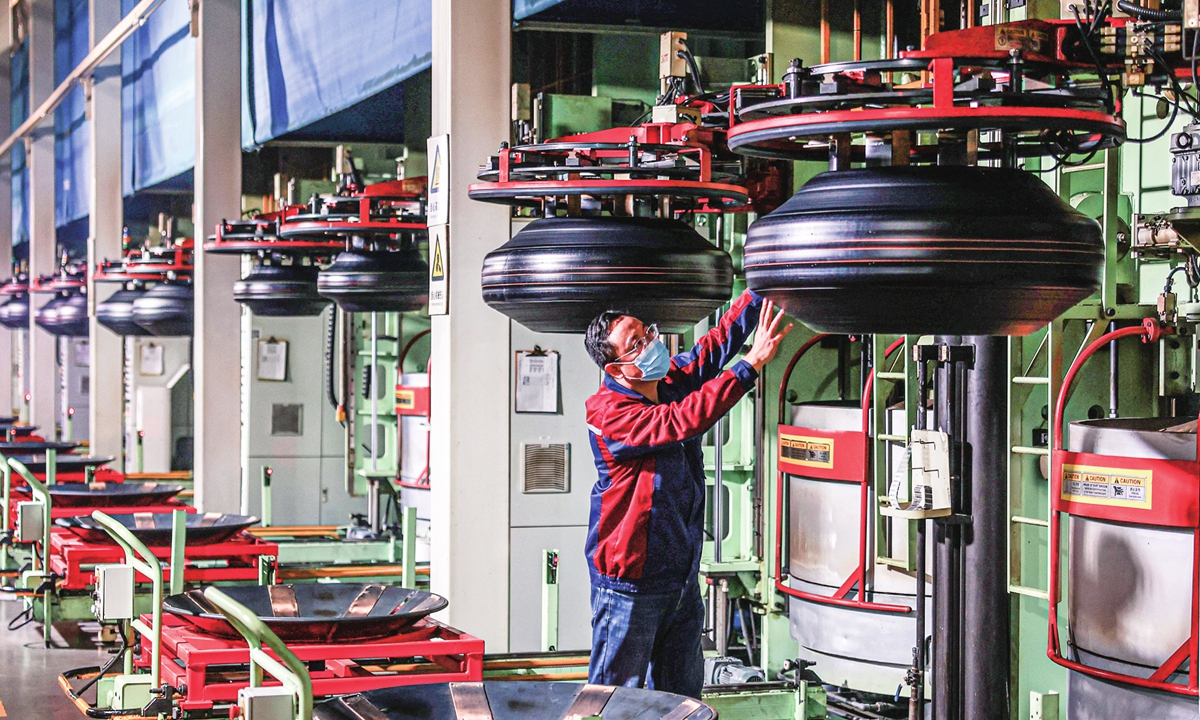 A worker is busy making tires for export in a company in Rongcheng, East China's Shandong Province on November 9, 2022. Official data showed that China's auto parts exports hit $53.03 billion from January to July, a year-on-year increase of 13.3 percent. Photo: cnsphoto