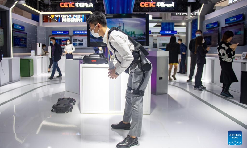 A staff member of China Electronic Technology Group Corporation (CETC) demonstrates a wearable exoskeleton robot during the Light of Internet Expo in Wuzhen, east China's Zhejiang Province, Nov. 8, 2022. The expo kicked off here on Tuesday.(Photo: Xinhua)