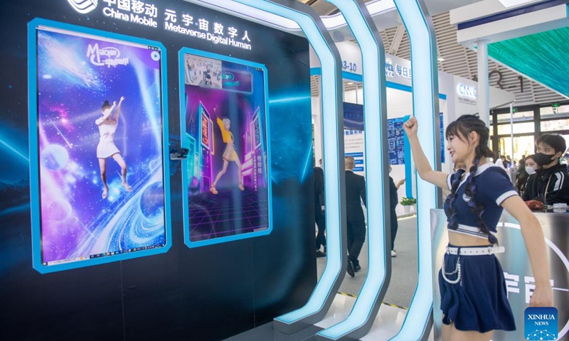 A woman plays an interactive dance game at the booth of China Mobile during the Light of Internet Expo in Wuzhen, east China's Zhejiang Province, Nov. 8, 2022. The expo kicked off here on Tuesday.(Photo: Xinhua)