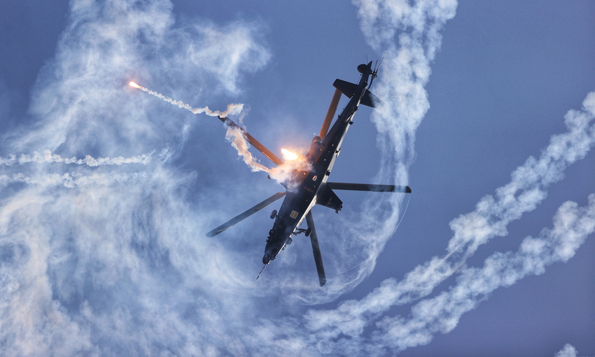 A Z-10 attack helicopter shoots flares while making a spin in the air. Flares can distract infrared guided missiles that have lock on the chopper. Photo: Cui Meng/GT