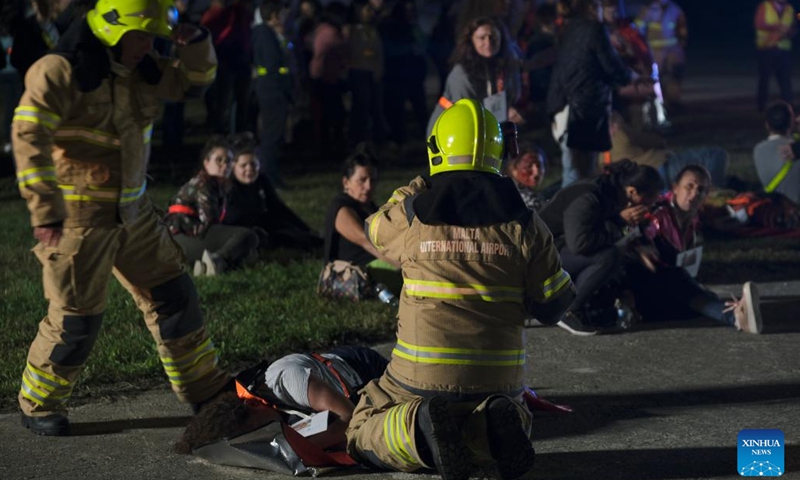This photo taken on Nov. 8, 2022 shows the scene of an aircraft emergency exercise at the Malta International Airport in Luqa, Malta. Firefighters, medical crews and other responders got themselves busy on Tuesday night as they responded to an aircraft emergency exercise designed to test preparedness levels in case of a real-life emergency at the Malta International Airport.(Photo: Xinhua)