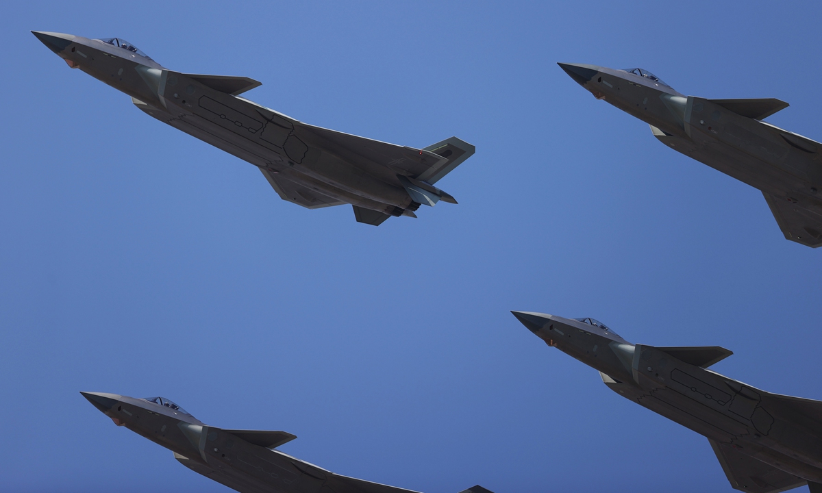Four J-20 stealth fighter jets in a diamond formation soar through the sky. Photo: Cui Meng/GT