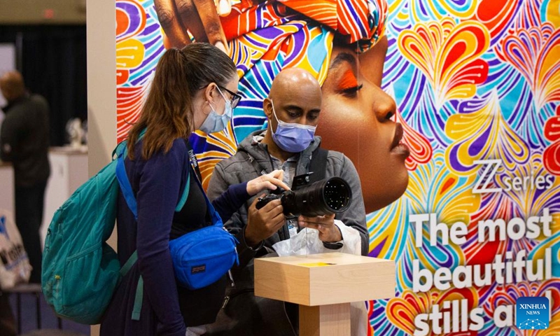 People look at a Nikon camera during the 2022 ProFusion Expo in Toronto, Canada, on Nov. 9, 2022. The two-day photography and videography event kicked off here on Wednesday in Canada and has drawn lots of imaging professionals and enthusiasts.(Photo: Xinhua)