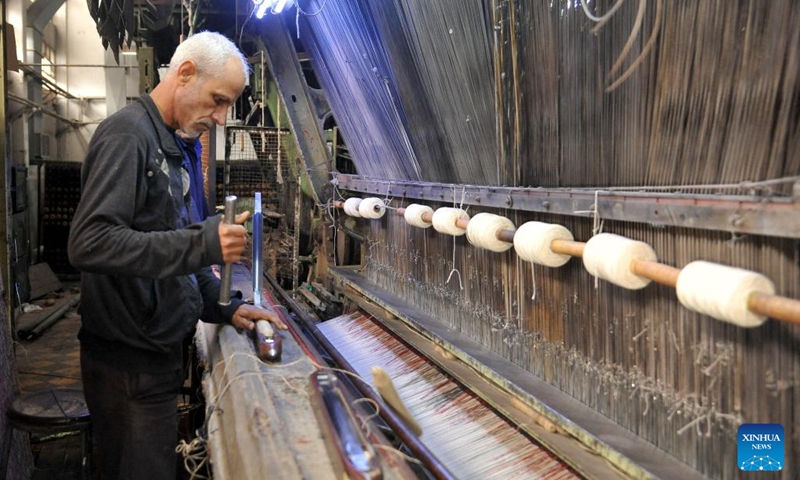 A man weaves carpets at a workshop in Damascus, Syria, on Nov. 10, 2022.(Photo: Xinhua)
