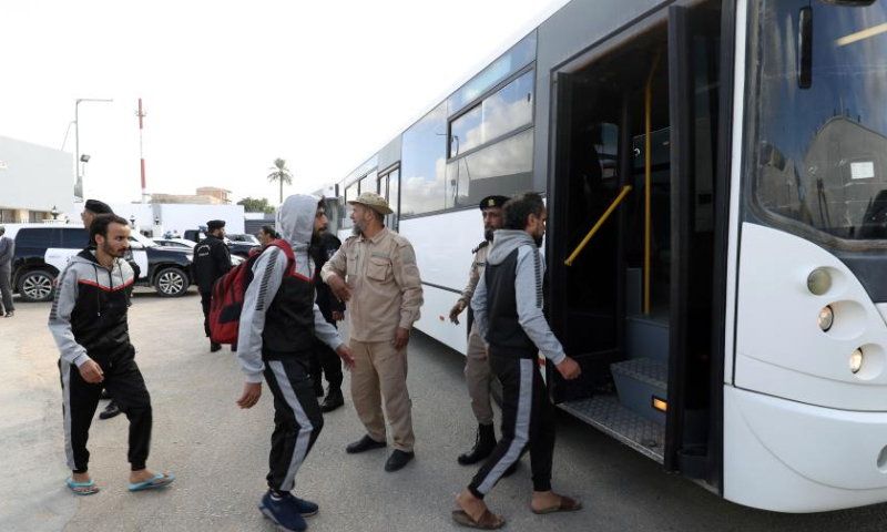 Illegal migrants get on a bus outside the Deportation Office of the Anti-illegal Immigration Department in Tripoli, Libya, on Nov. 24, 2022. The Libyan Anti-illegal Immigration Department on Thursday deported more than 200 illegal migrants to their countries of origin. (Photo by Hamza Turkia/Xinhua)