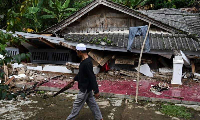 A resident walks in front of a damaged house at Mangunkerta village in Cianjur, West Java, Indonesia, Nov. 24, 2022. The strong quake striking West Java province on Monday displaced 62,545 residents in Cianjur district, one of the hardest-hit areas, and a total of 14 evacuation centers have been established, head of the National Disaster Management Agency Suharyanto said on Thursday. (Xinhua/Veri Sanovri)