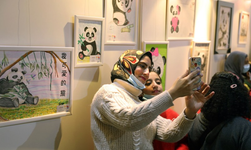 People take selfie during the exhibition of works of the 