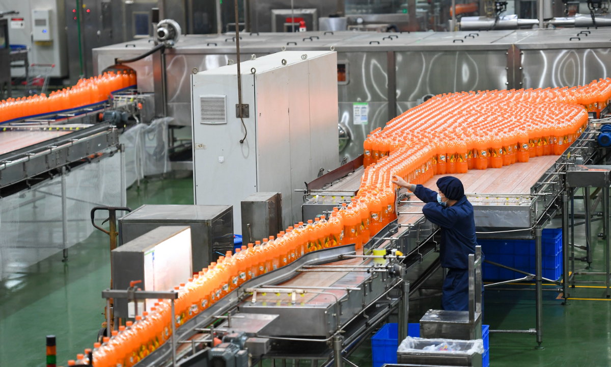 A worker checks packages of beverages at a food company in Changsha, Central China's Hunan Province on December 13, 2022. Food processing enterprises in Changsha have ushered in the peak season of production and sales, and their employees are rushing to fill orders. Photo: VCG