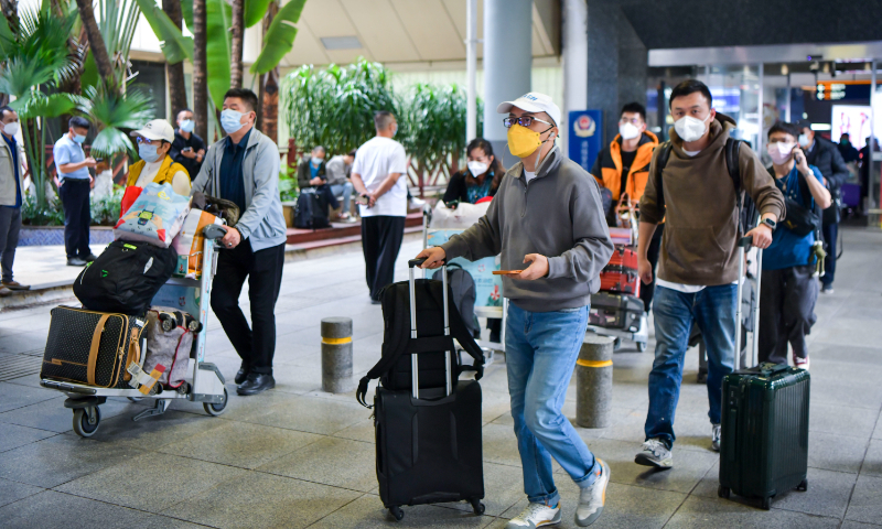 Passengers walk out of Haikou Meilan International Airport on December 9, 2022. Photo: VCG