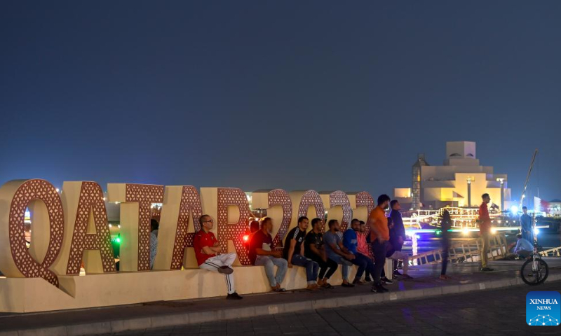 People rest near a FIFA World Cup 2022 installation in Doha, Qatar, on Nov. 14, 2022. Photo: Xinhua