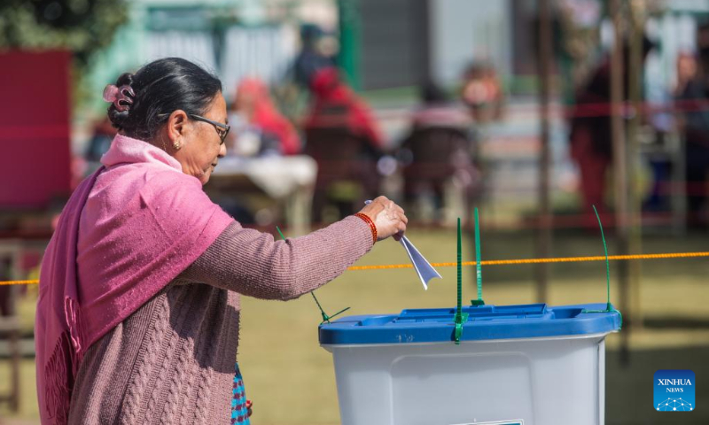 A woman casts her ballot during the general elections in Lalitpur, Nepal, Nov. 20, 2022. Nepalis went to the polls on Sunday morning for elections to the House of Representatives of the federal parliament and seven provincial assemblies. (Photo by Hari Maharjan/Xinhua)