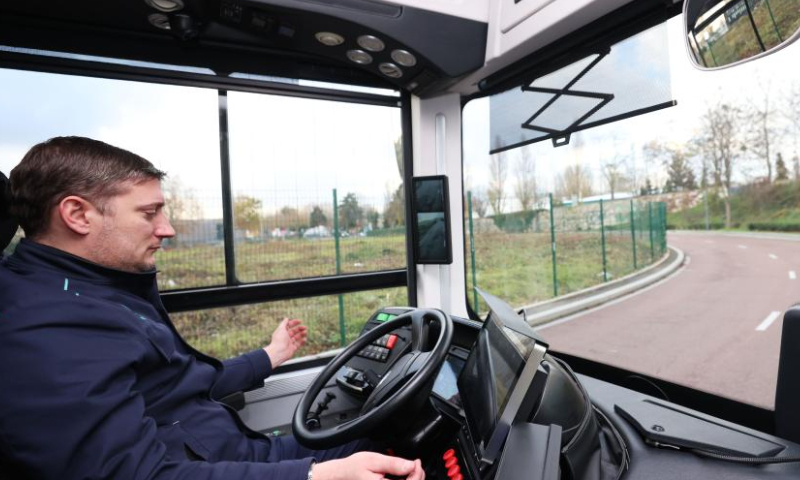 A driver reacts during a trial run of a self-driving bus made by China's CRRC Electric Vehicle at the suburb of Paris, France, Dec. 7, 2022. The self-driving bus made by China's CRRC Electric Vehicle has completed its trial run on open road and been ready to start official operations with passengers. (Xinhua/Gao Jing)