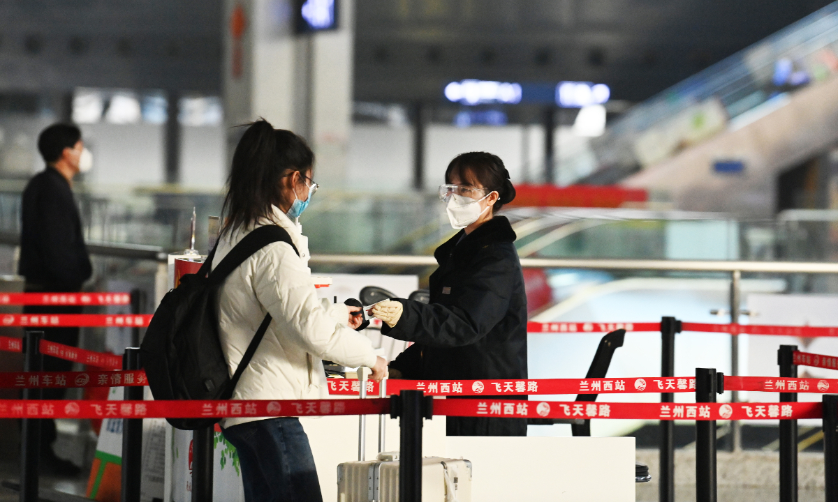 Passengers use their ID cards to enter a railway station in Lanzhou, Northwest China's Gansu Province on December 9, 2022. Starting from December 7, China Railway scrapped the previous requirement for a 48-hour negative nucleic acid result and health code for travel by train. Photo: IC