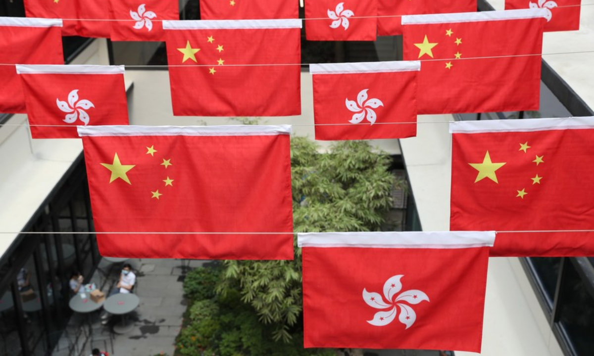 China's national flag (five-star red flag) and the flag of the Hong Kong Special Administrative Region are seen in south China's Hong Kong, Oct 1, 2021. Photo:Xinhua