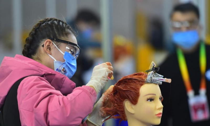 A contestant participates in a hairdressing contest during the first vocational skills competition of Jiangxi, in Nanchang, east China's Jiangxi Province, Dec. 2, 2022. The main contests of the competition, containing 85 programs, kicked off in Nanchang on Friday. (Xinhua/Peng Zhaozhi)?