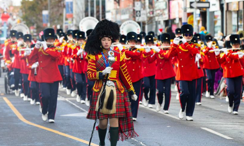 A marching band performs during the 2022 Toronto Santa Claus Parade in Toronto, Canada, on Nov. 20, 2022. Featuring themed floats and marching bands, the annual parade returned in-person here on Sunday this year. (Photo by Zou Zheng/Xinhua)