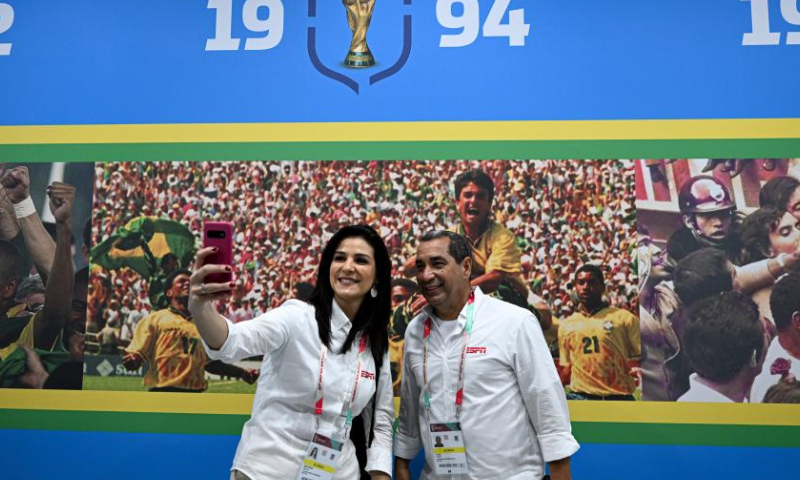 Two journalists take selfies inside the Al Arabi SC stadium which will host the Brazil national team during a media tour in Doha, Qatar, Nov. 19, 2022. (Xinhua/Xin Yuewei)