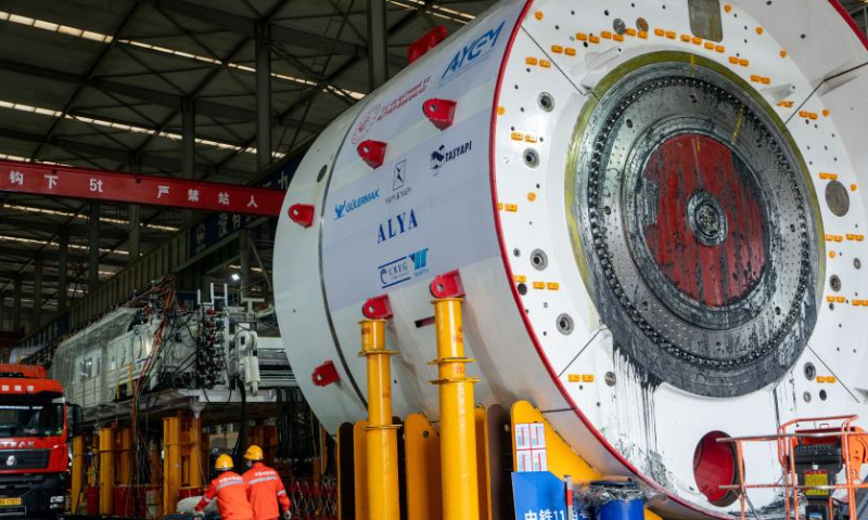 Employees transport the components of a tunnel boring machine at a workshop of China Railway Engineering Equipment Group Co., Ltd. (CREG) in Zhengzhou, central China's Henan Province, Nov. 23, 2022. Tunnel boring machines made by CREG have been exported to more than 30 countries and regions for major projects, which are actively serving tunnel construction projects globally. (Xinhua)