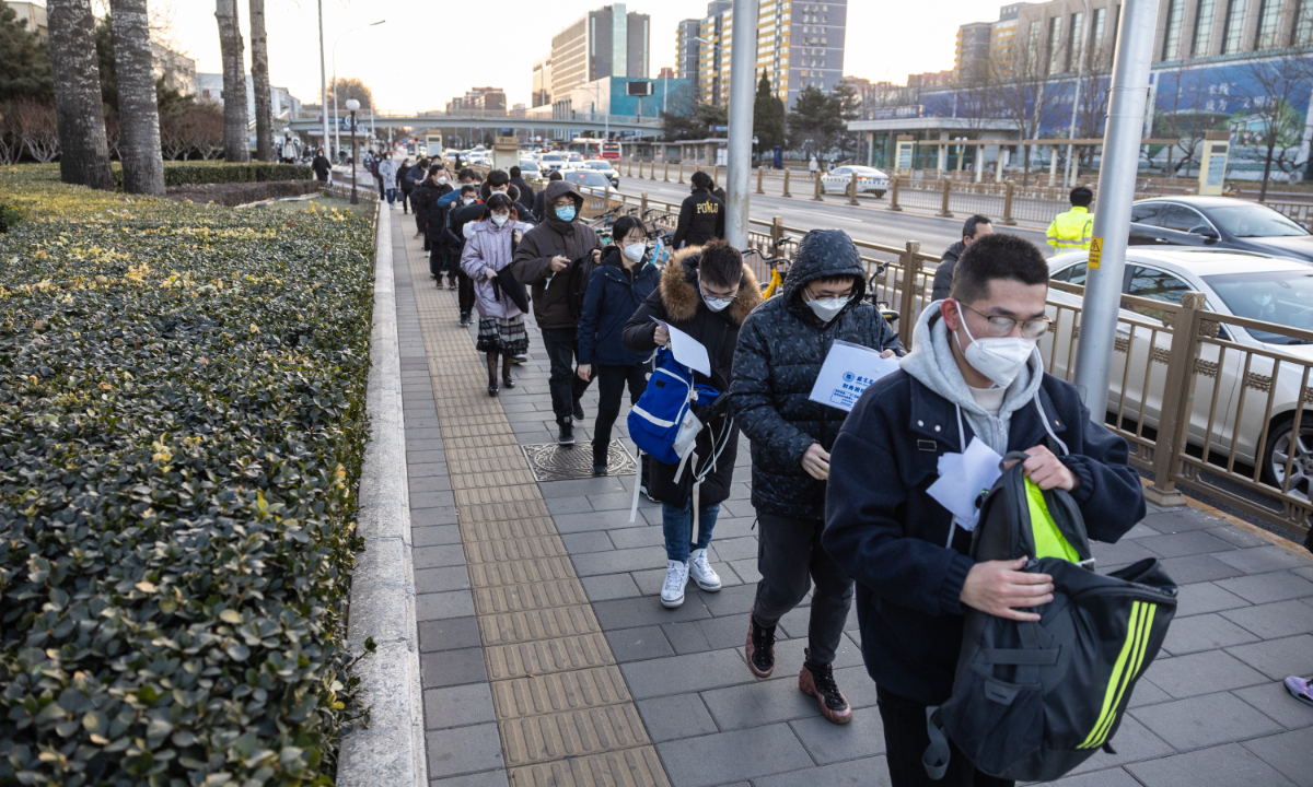 Examinees wait in long queues at the entrance to the Yuquanlu campus of the University of Chinese Academy of Sciences in Beijing to take part in China's national postgraduate admission examinations held from December 24 to 26. Photo: Li Hao/GT