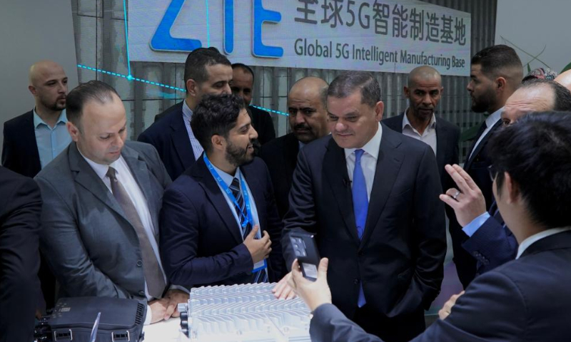 Prime Minister of Libya's Government of National Unity Abdul-Hamed Dbeibah (3rd L, Front) visits the booth of the Chinese telecom company ZTE at the Libya International Telecommunications and Information Technology Exhibition in Tripoli, Libya, on Nov. 14, 2022. More than 200 companies in the Libyan communications industry participated in the four-day event, which aims to promote high-end technical exchanges in the Libyan communications industry and play a key role in Libya's future network development, according to its organizer. Photo: Xinhua