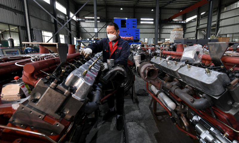 Workers are busy making engines for overseas orders at a factory in Ningde, East China's Fujian Province on December 5, 2022. These products, such as diesel engines and generators, are exported to Europe, North America, Africa and Southeast Asian countries. Photo: cnsphoto