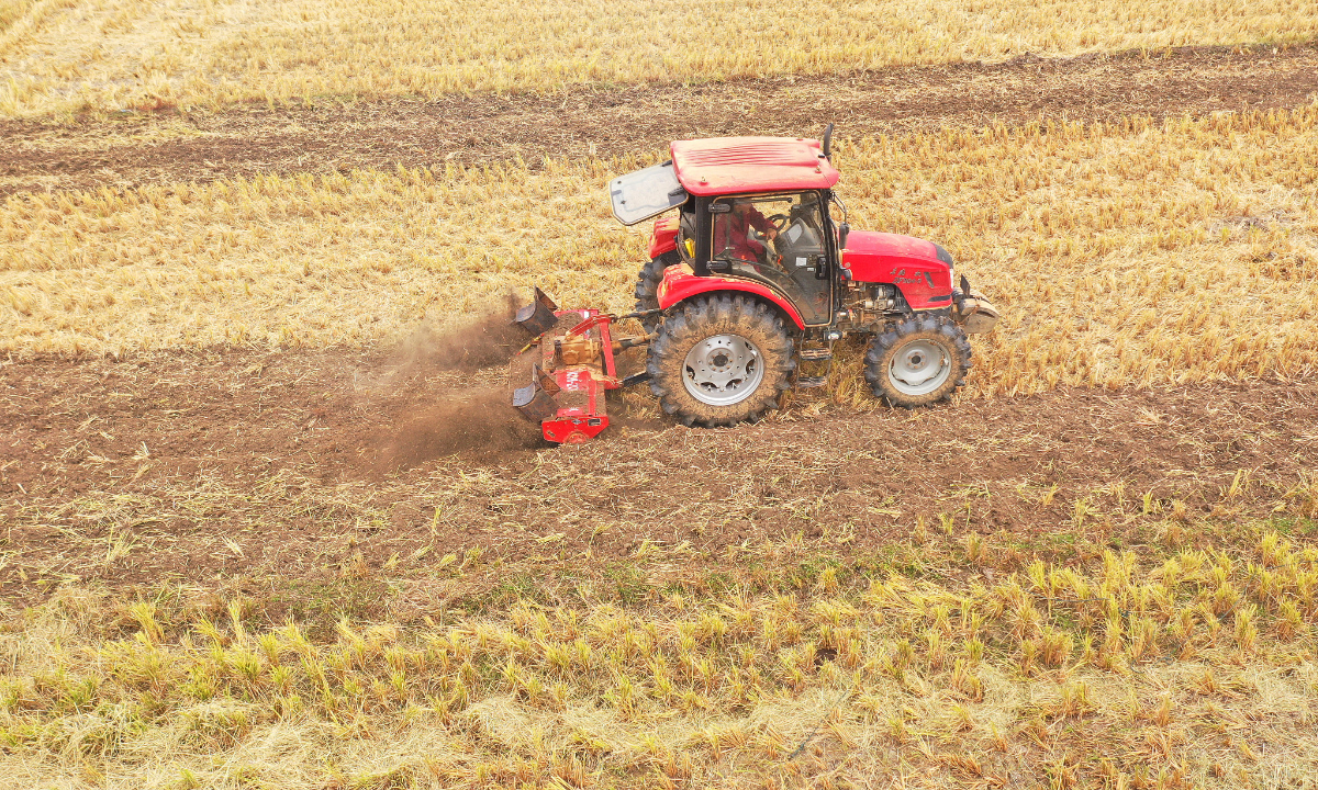 A farmer operates a tractor to plough and prepare for sowing winter grain in Taihe county, East China's Jiangxi Province on October 27, 2022. Photo: VCG