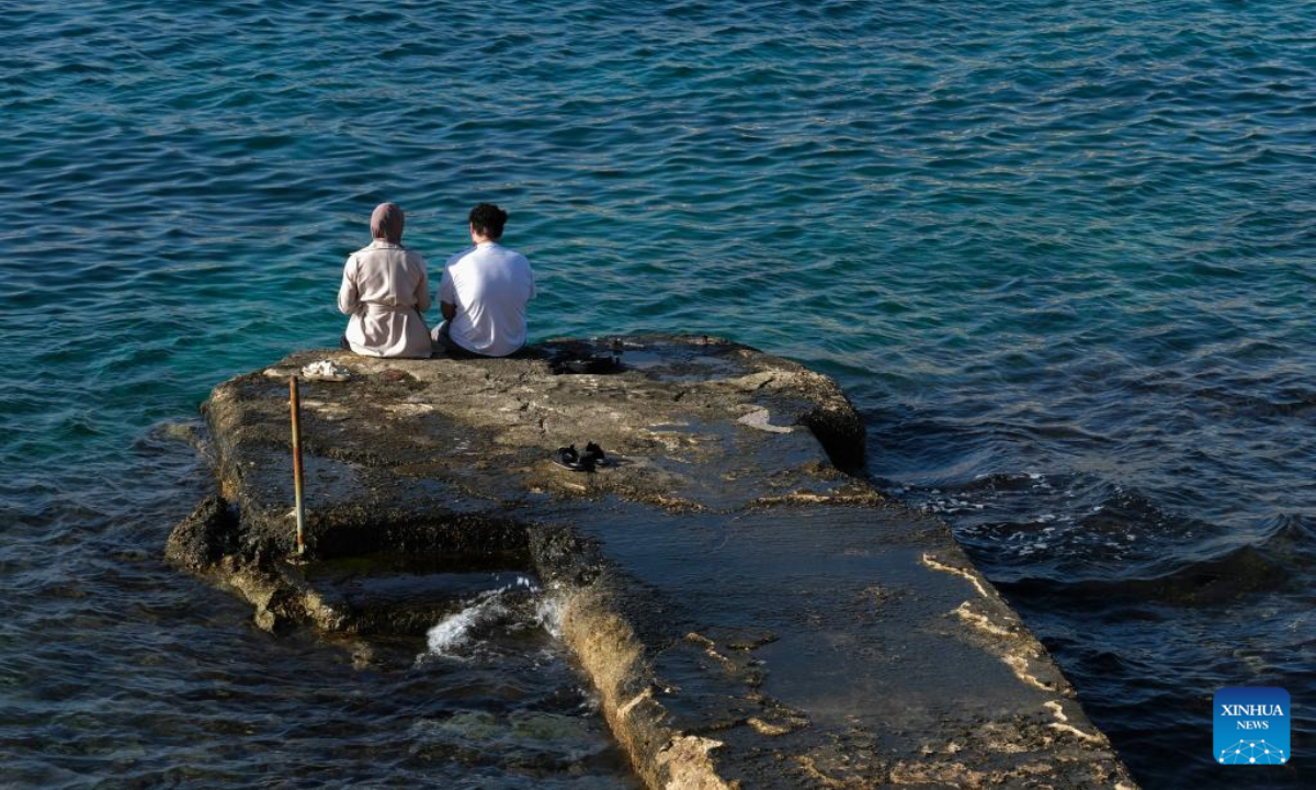 People spend time at the seaside of the Mediterranean Sea in Sliema, Malta, on Dec. 16, 2022. The maximum temperature reached 24 degrees Celsius in Malta on Friday, the warmest December day in almost 60 years, according to the country's meteorological office. Photo:Xinhua