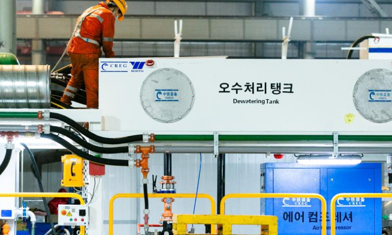 An employee debugs a tunnel boring machine at a workshop of China Railway Engineering Equipment Group Co., Ltd. (CREG) in Zhengzhou, central China's Henan Province, Nov. 23, 2022. Tunnel boring machines made by CREG have been exported to more than 30 countries and regions for major projects, which are actively serving tunnel construction projects globally. (Xinhua)