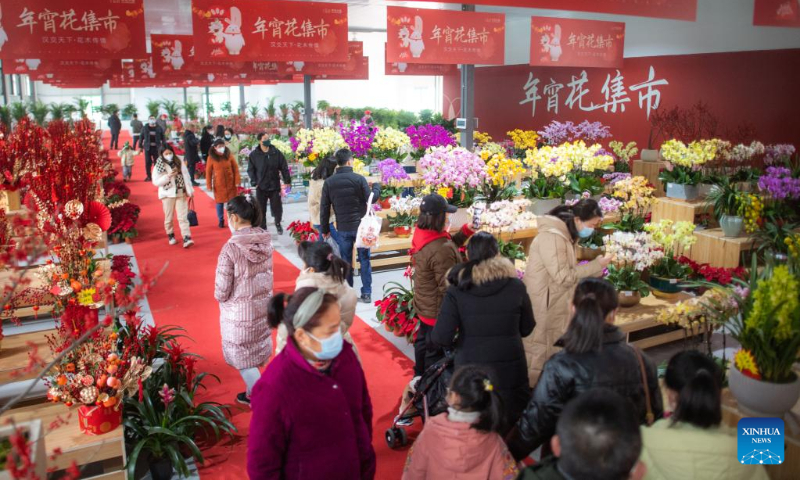 People visit a flower market in Wuhan, central China's Hubei Province, Jan. 1, 2023. The three-day New Year holiday witnessed a strong recovery in tourism, catering and retail sales across the country. (Xinhua/Xiao Yijiu)