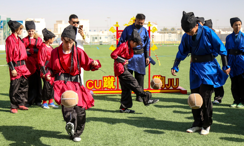 China-Qatar Youth Soccer Exchange and Experience Activity is held at the FIFA Fan Festival inside Al Bidda Park in Doha, Qatar on November 21, 2022, where young players are seen wearing traditional cuju clothes. Photo: Courtesy of Network of International Cultural-link Entities