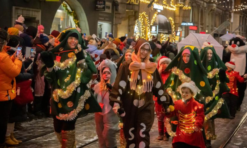 People participate in the Christmas opening celebration in Helsinki, Finland, Nov. 19, 2022. The Christmas opening celebration was held in central Helsinki on Saturday with a glittering parade, marking the start of the festive season. (Photo by Matti Matikainen/Xinhua)