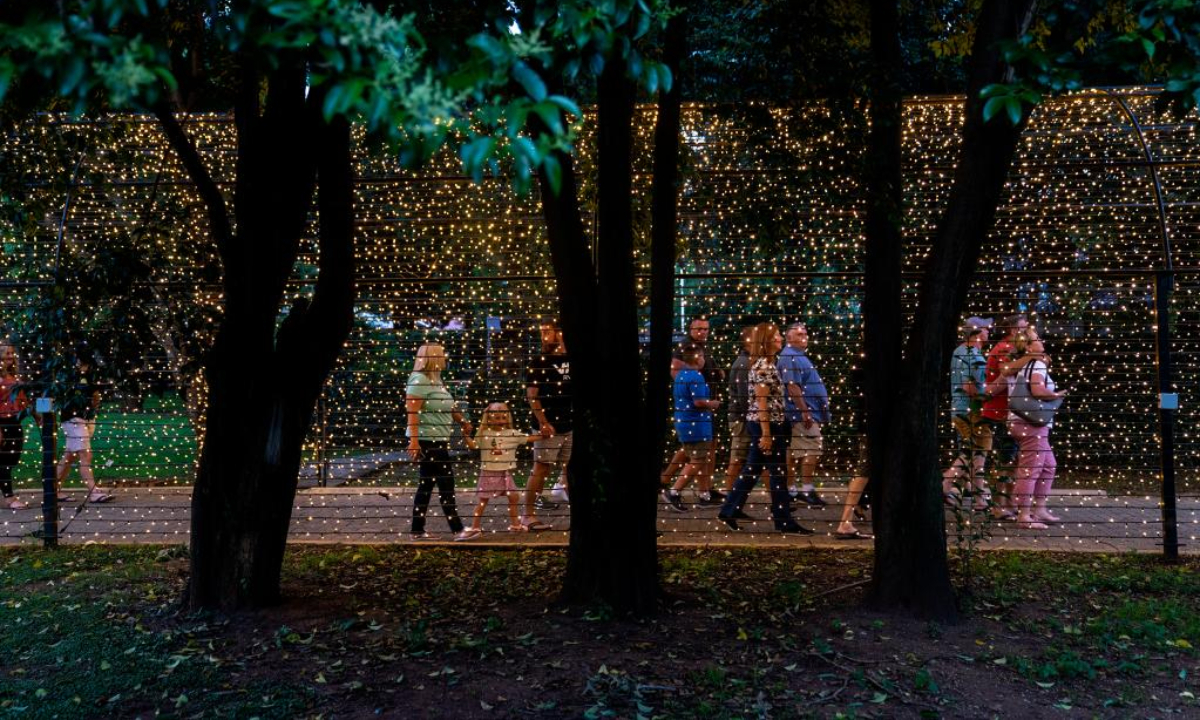 People walk through a light tunnel at a light fair in Potchefstroom, South Africa, Dec 22, 2022. Photo:Xinhua