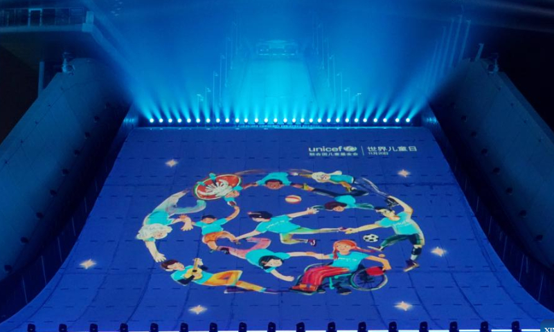 Shougang ski jumping platform is lit up to celebrate World Children's Day in Beijing, capital of China, Nov. 20, 2022. (Xinhua/Zhang Chenlin)