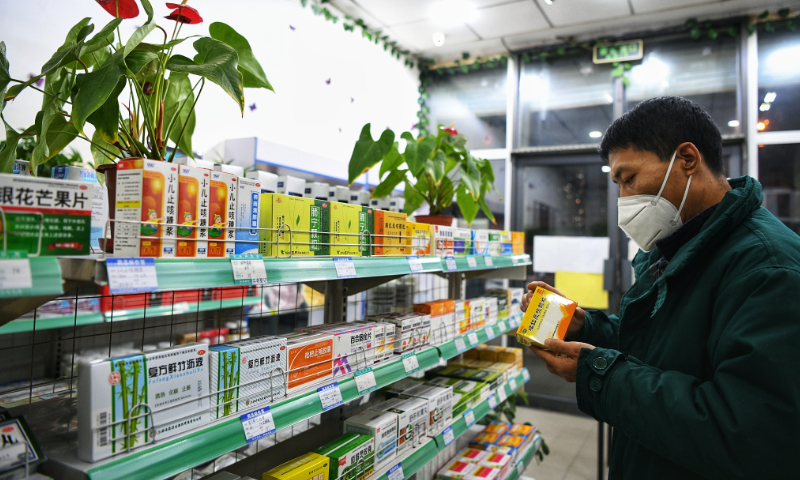 A local resident is buying medicine for cough in a pharmacy in Tianjin on December 6, 2022. Photo: VCG