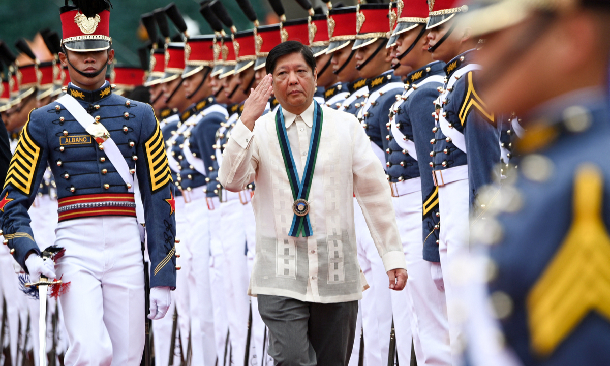 Philippine President Ferdinand Marcos Jr (center) salutes troops during the 87th anniversary celebration of the Armed Forces of the Philippines, at the military headquarters in Quezon city in suburban Manila on December 19, 2022. Photo: AFP