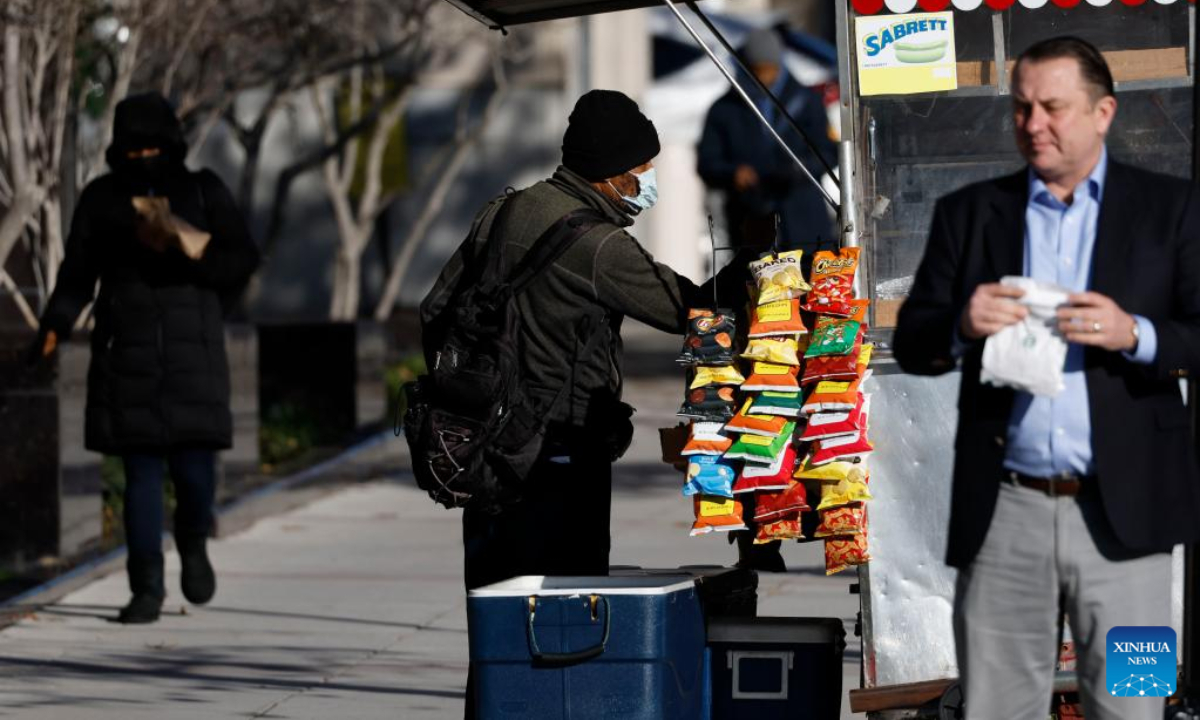 A man wearing a face mask is seen on a street in Washington, DC, the United States, on Dec 16, 2022. Photo:Xinhua