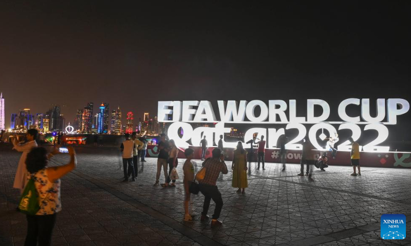 People take photos with a FIFA World Cup 2022 installation near the Doha Corniche in Doha, Qatar, on Nov. 14, 2022. Photo: Xinhua